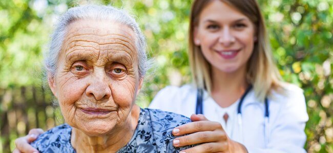 Infermiera si prende cura di una donna anziana con Alzheimer